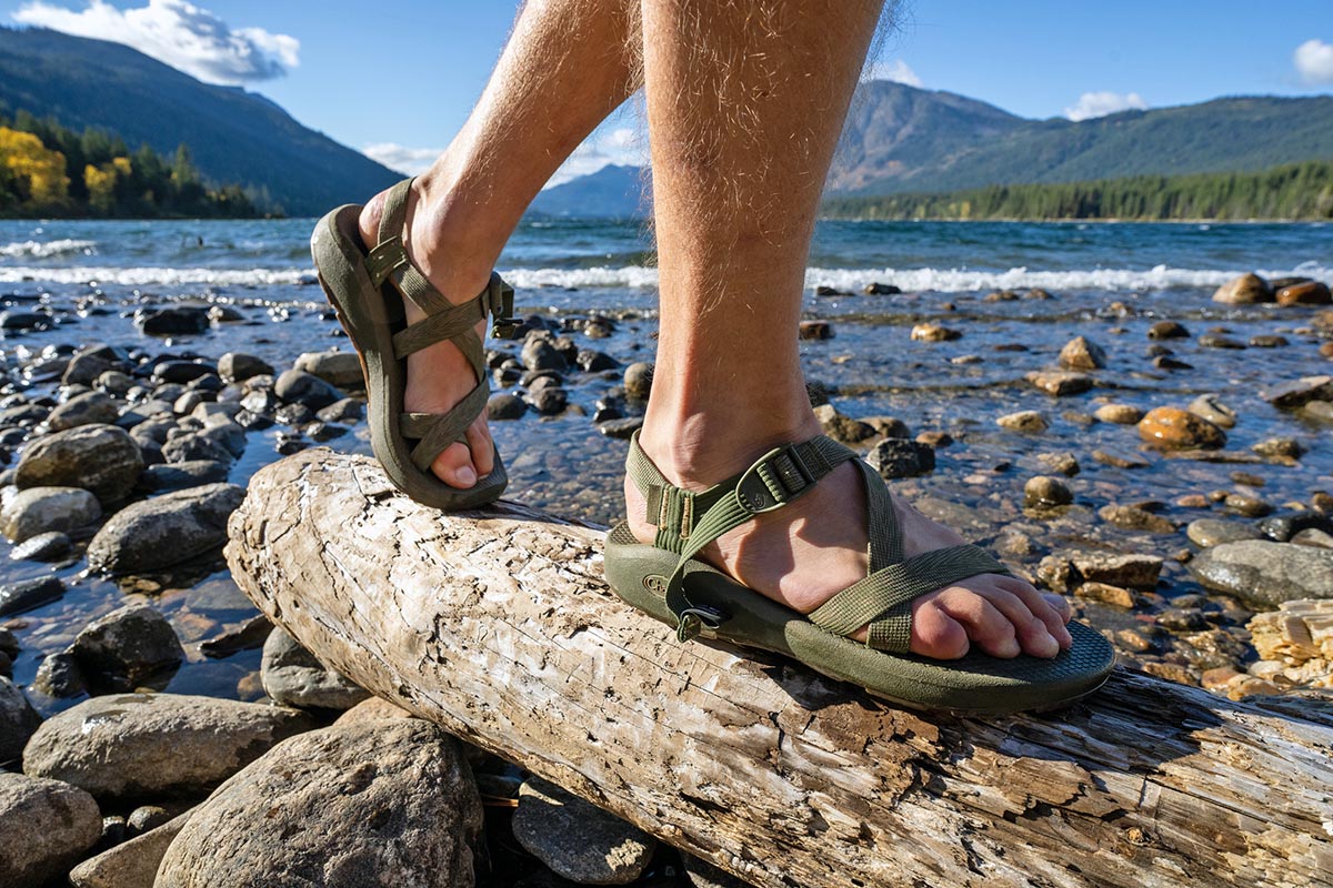 Front Page -Sandals Sales Sports sandals hiking over log on beach in Chaco sandals